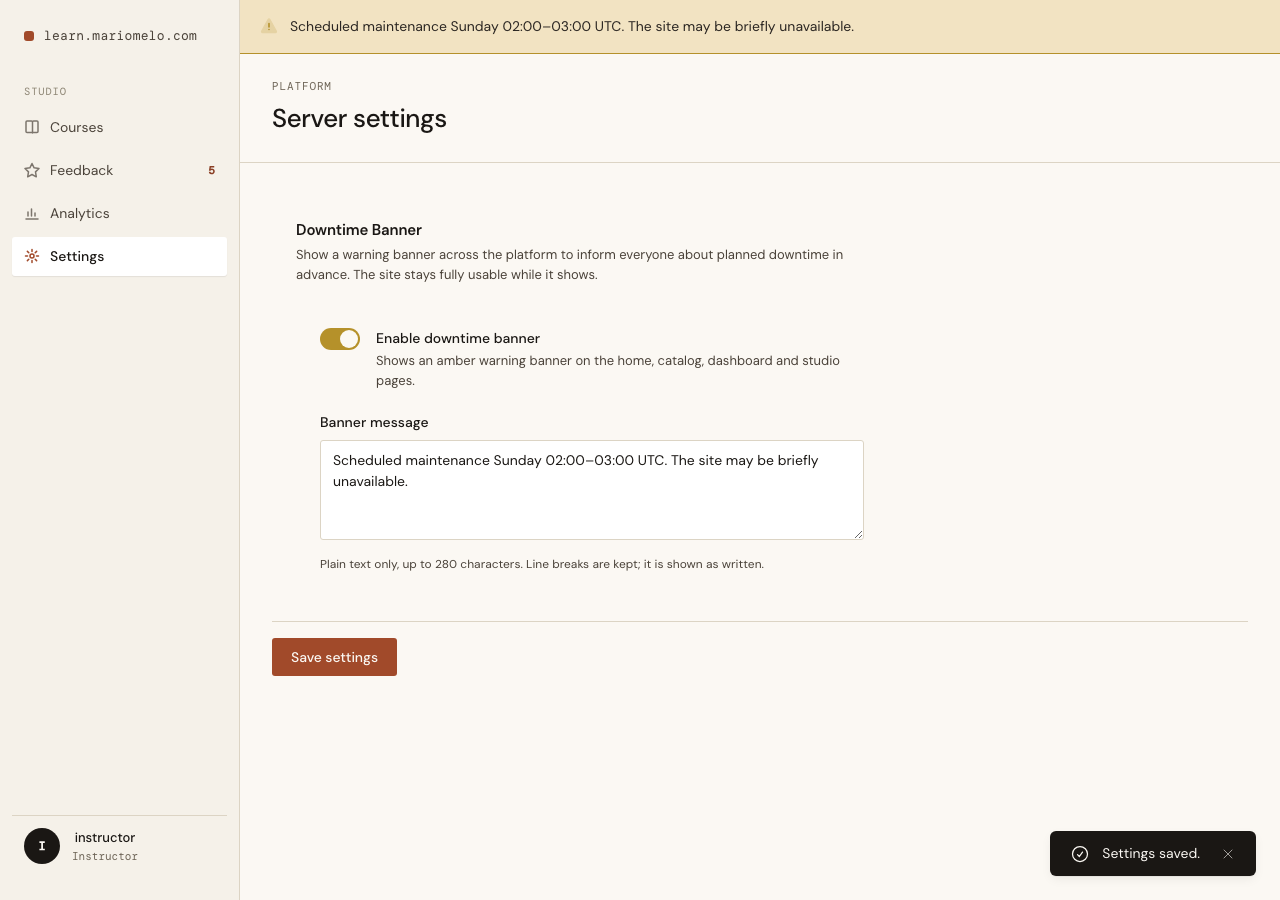 The Server Settings page: the Downtime Banner section with its toggle on, the message textarea, and the amber banner already rendered across the top of the Studio itself.