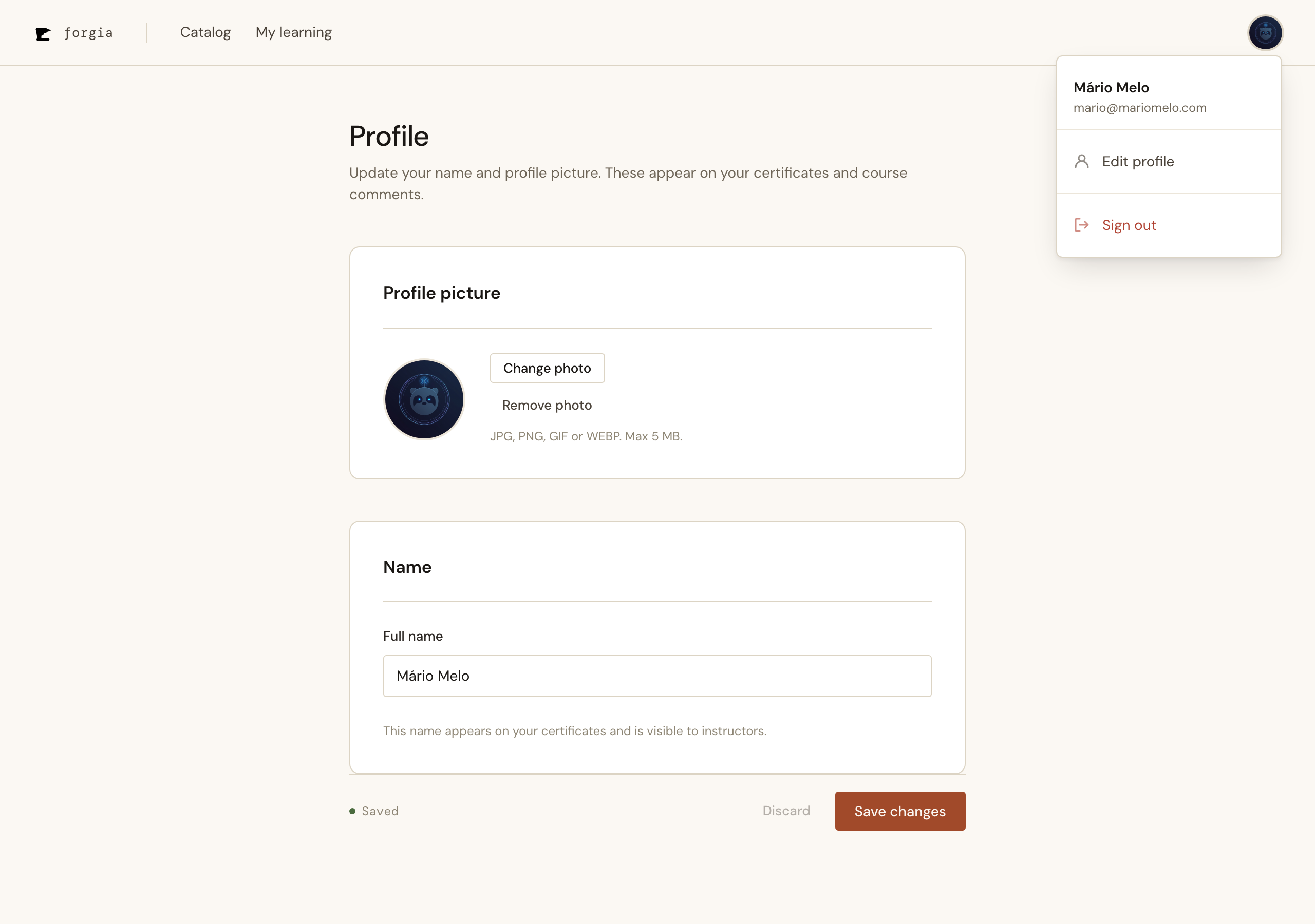 The /profile page with the account dropdown open